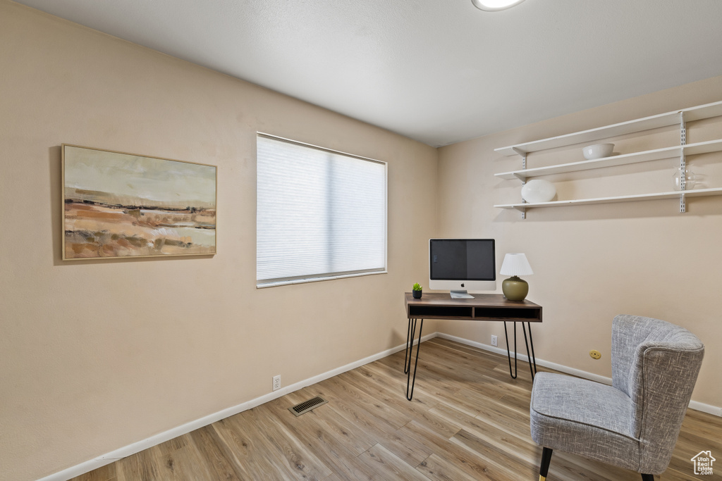 Office area with wood finished floors and baseboards