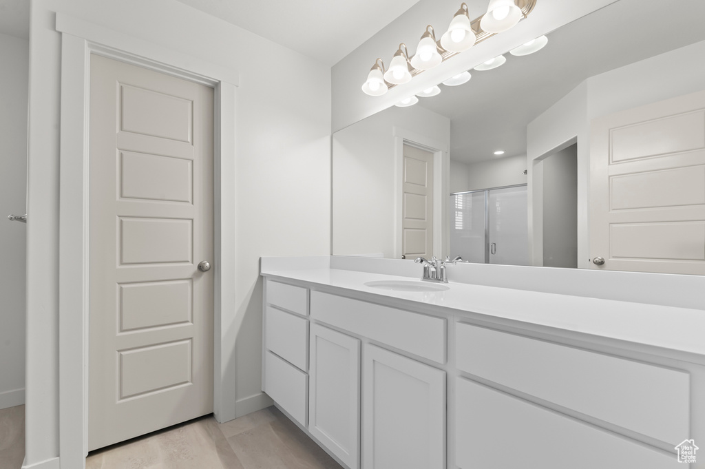 Bathroom with a stall shower and vanity