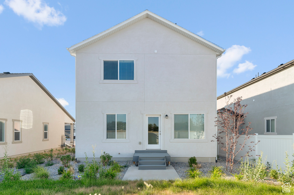 Rear view of house with stucco siding