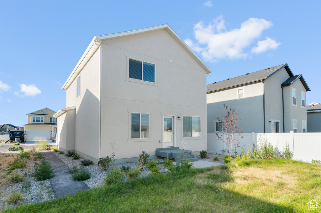 Back of property featuring stucco siding