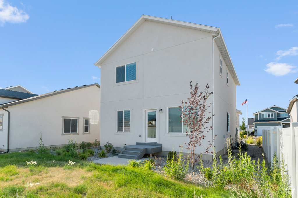 Rear view of property with stucco siding