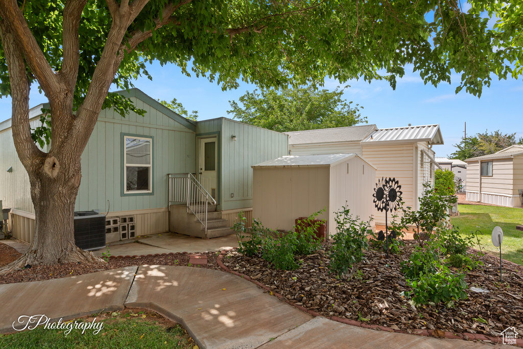 View of front of home featuring a shed and a patio