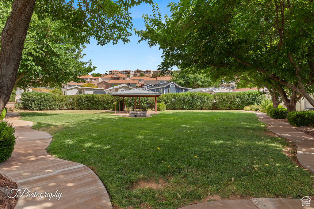 View of green lawn featuring a gazebo and a residential view