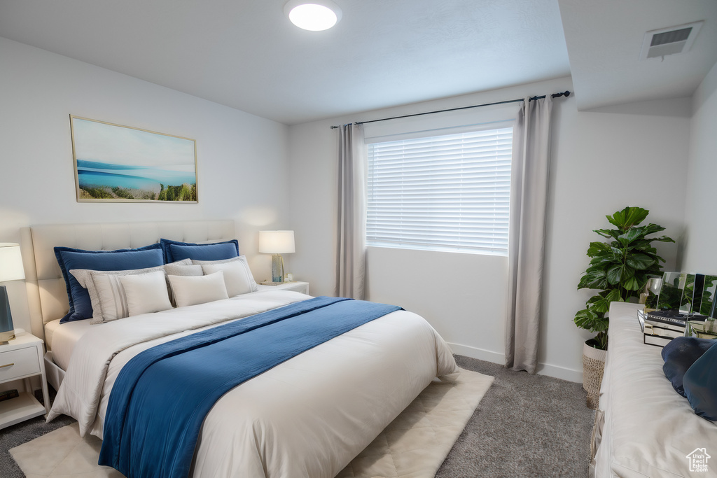 Bedroom with light carpet and baseboards