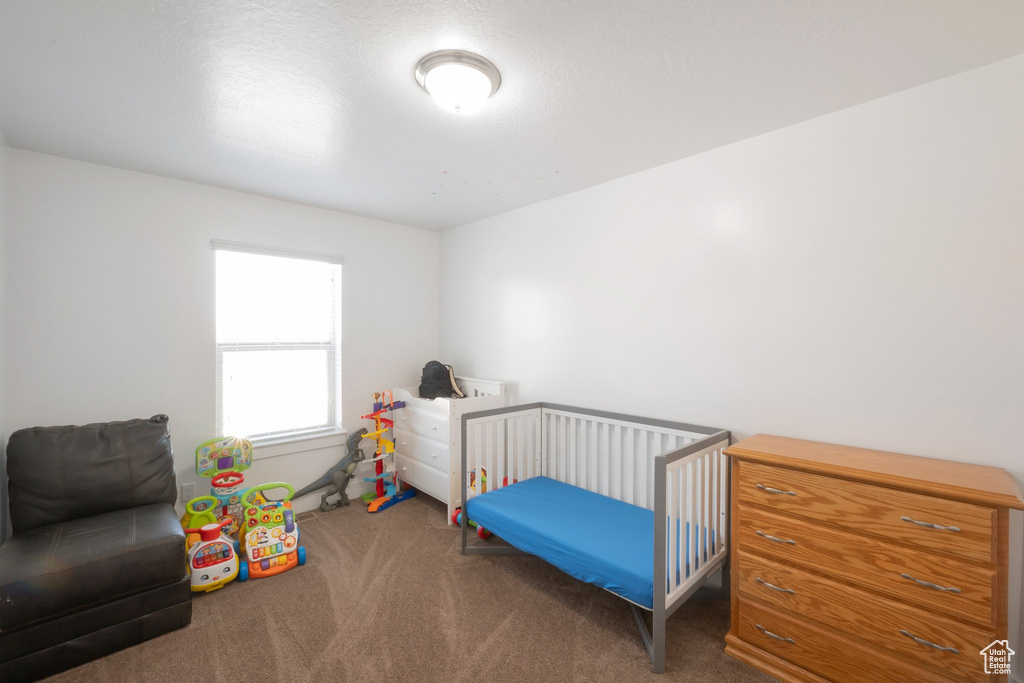 Carpeted bedroom featuring baseboards