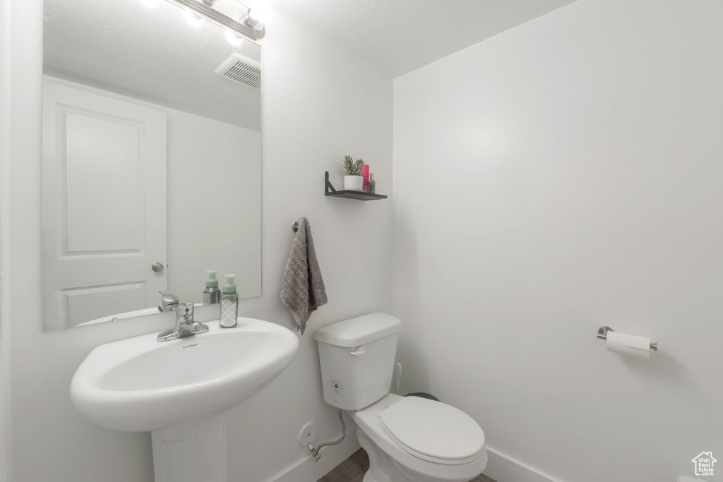 Bathroom with toilet and baseboards