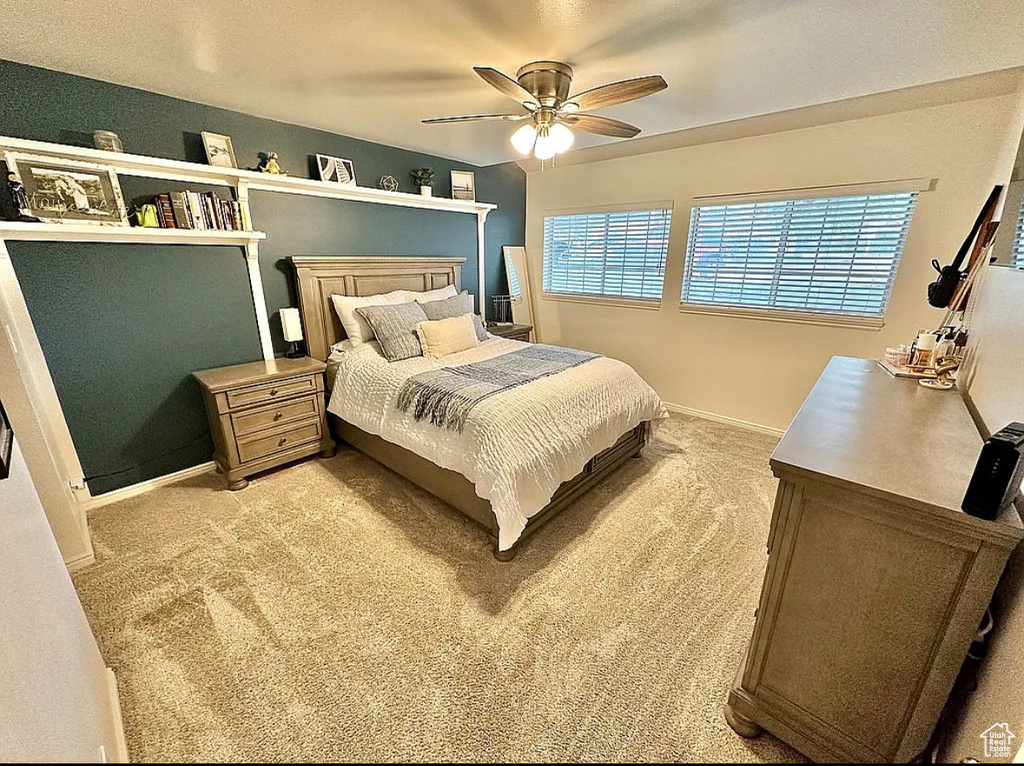 Bedroom featuring light colored carpet and ceiling fan