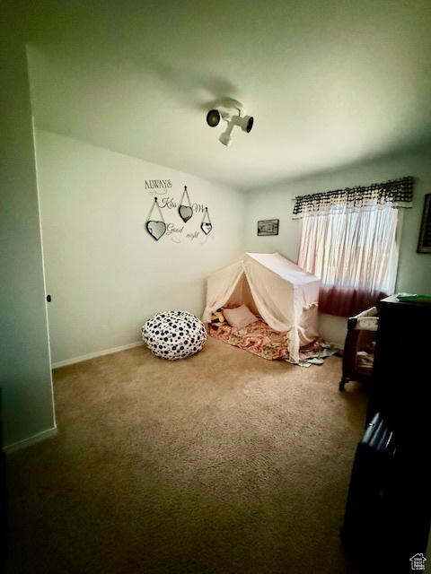 Carpeted bedroom featuring baseboards