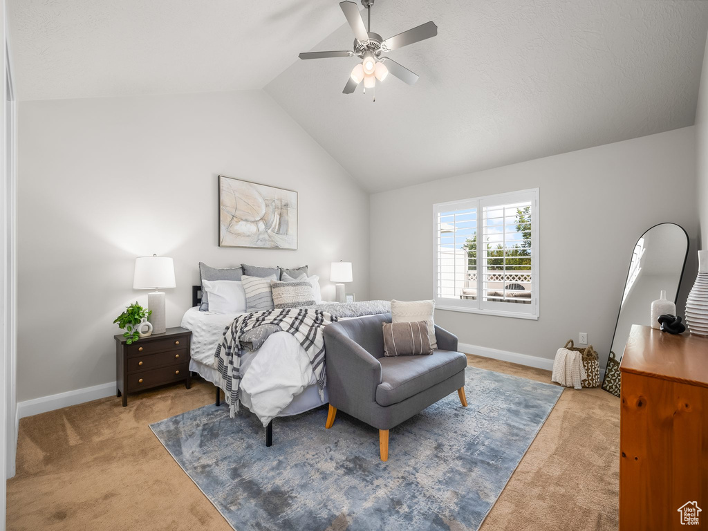 Bedroom with carpet floors, vaulted ceiling, and a ceiling fan