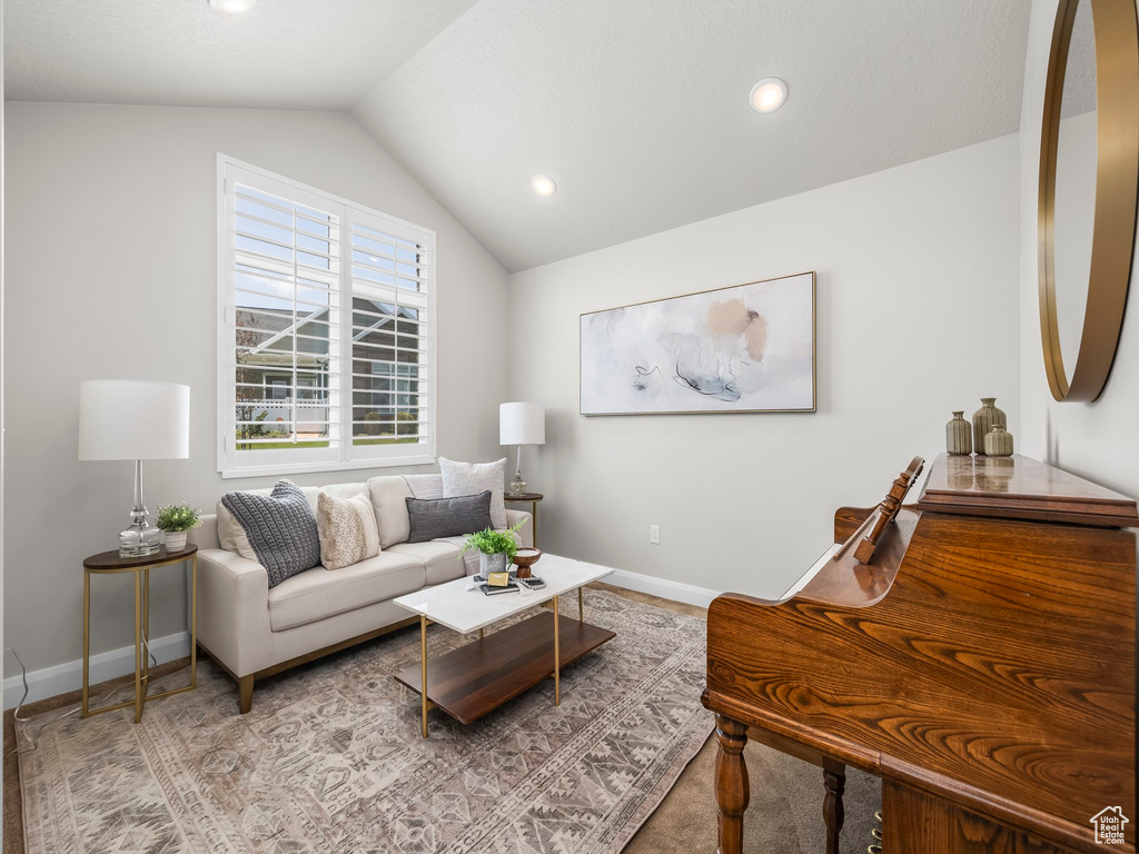 Living area featuring lofted ceiling and recessed lighting