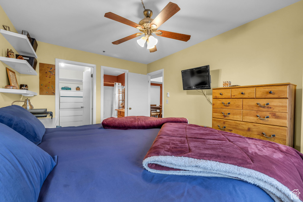 Bedroom with a ceiling fan and ensuite bath