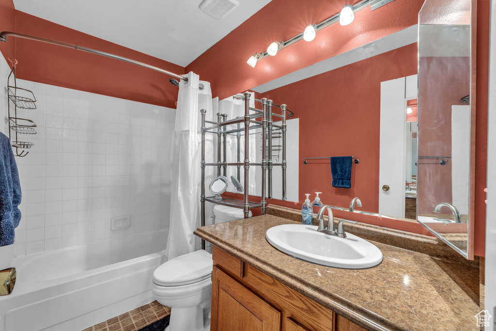 Bathroom with shower / bathtub combination with curtain and vanity