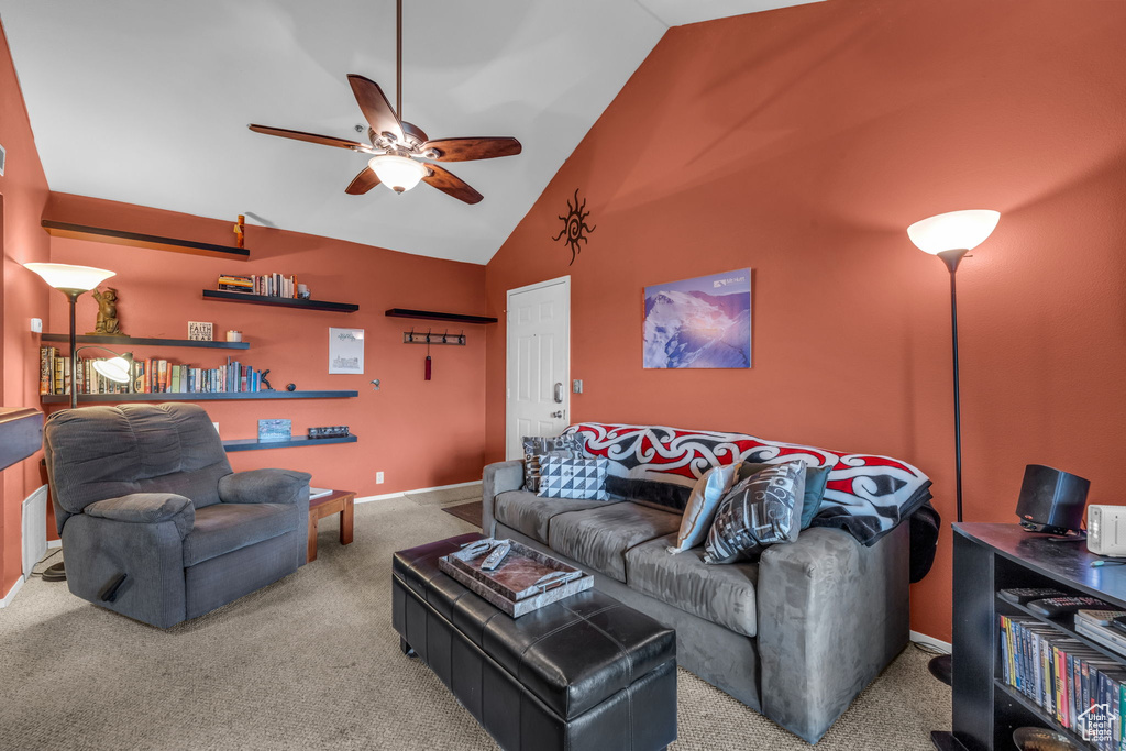 Living area featuring a ceiling fan, carpet flooring, and high vaulted ceiling