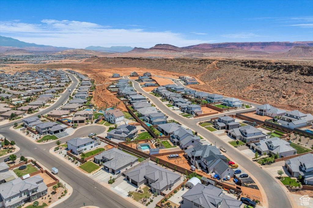 Aerial overview of property's location with mountains and nearby suburban area