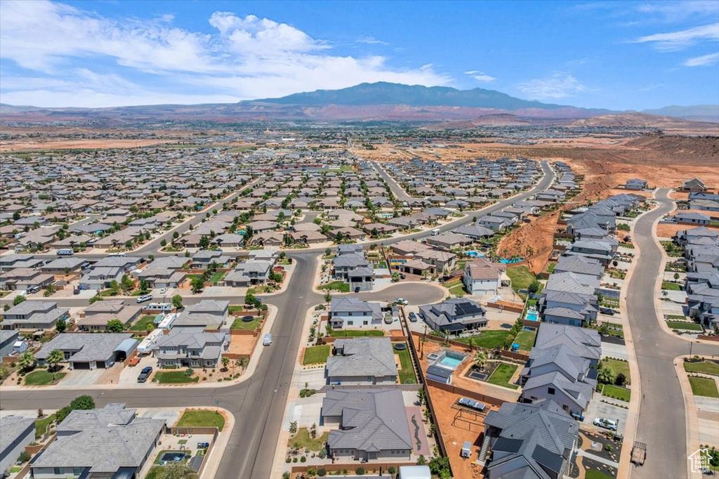 Aerial view of property and surrounding area featuring nearby suburban area