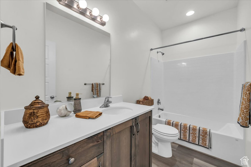 Full bathroom featuring vanity, bathtub / shower combination, and wood finished floors
