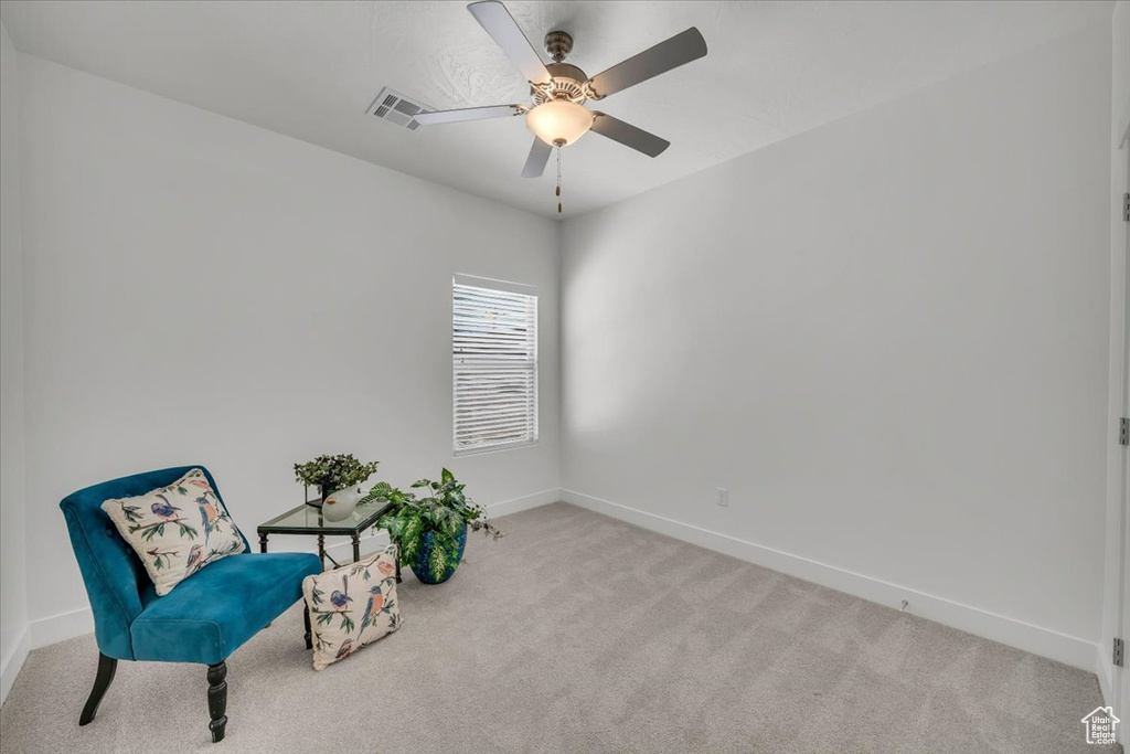 Unfurnished room with light colored carpet and ceiling fan