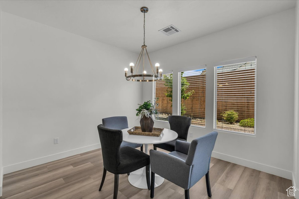 Dining space featuring a chandelier and light wood-style flooring