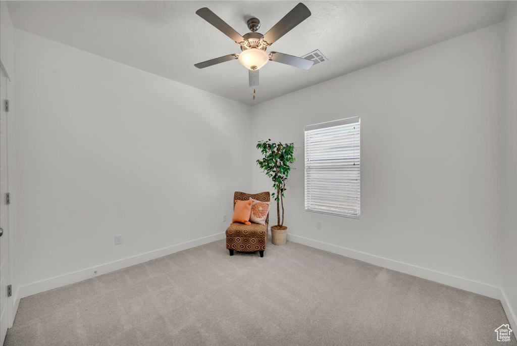 Sitting room featuring carpet flooring and ceiling fan