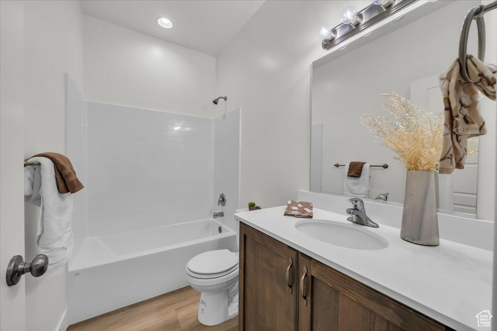 Full bathroom featuring vanity, wood finished floors, and bathing tub / shower combination