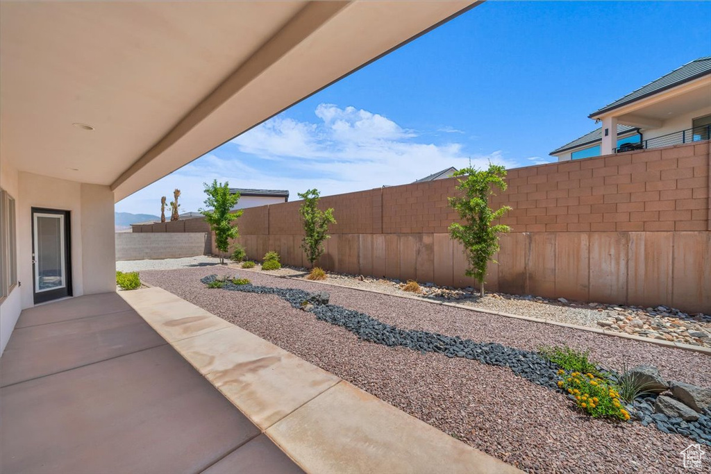 Fenced backyard featuring a patio