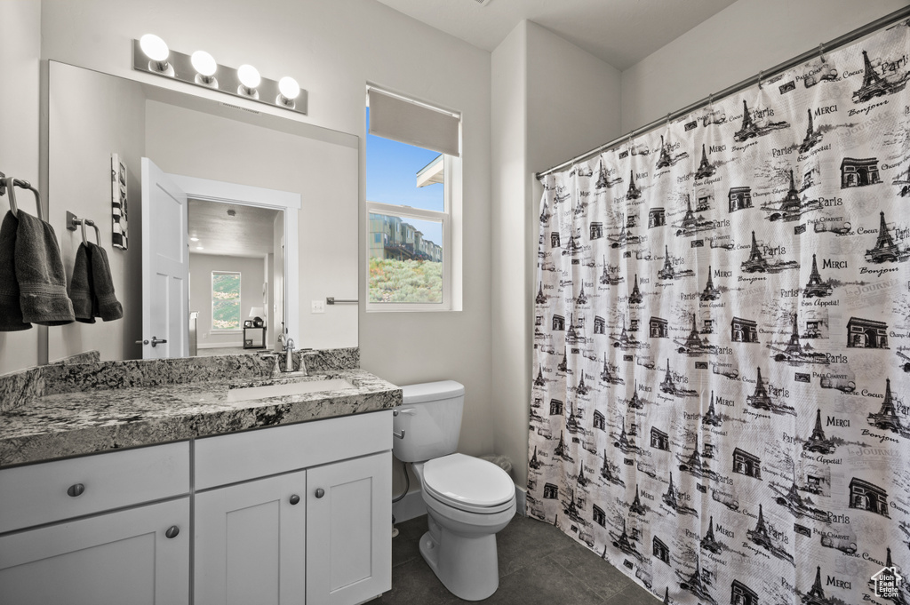 Bathroom featuring vanity, tile patterned floors, and a shower with shower curtain