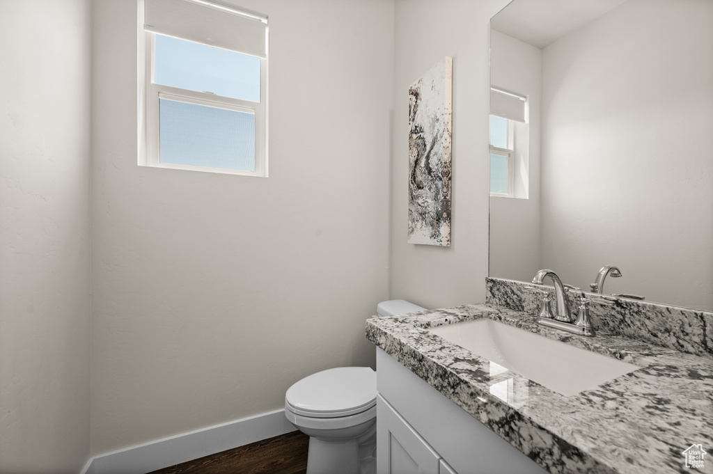 Bathroom featuring vanity and wood finished floors