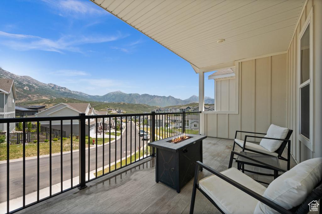 Balcony featuring an outdoor fire pit and a mountain view
