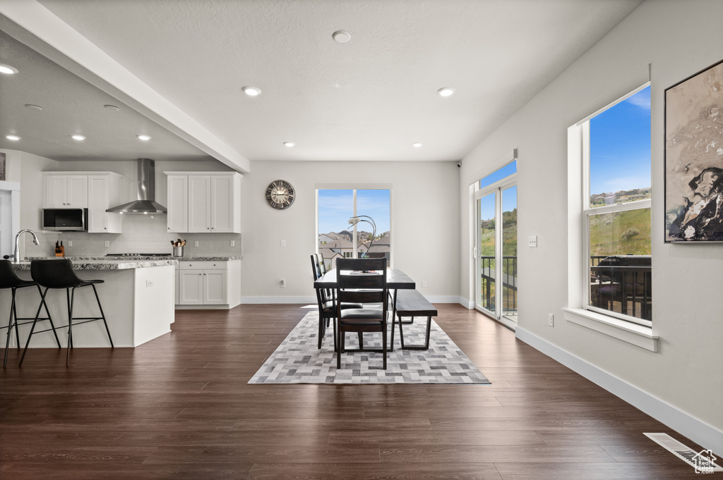Dining room with recessed lighting and dark wood-type flooring
