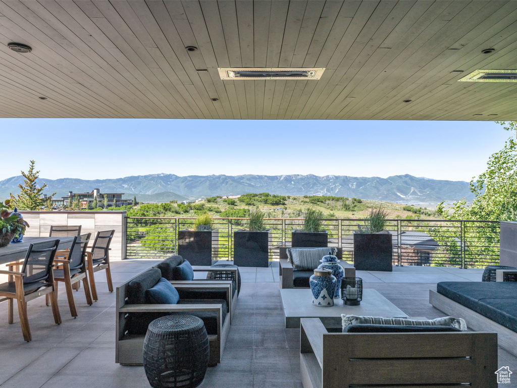 View of patio featuring an outdoor hangout area, a mountain view, and outdoor dining space