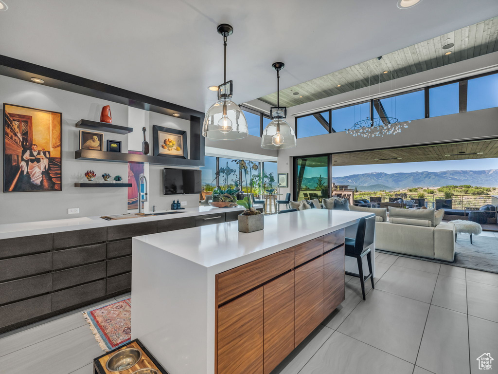 Kitchen with light countertops, modern cabinets, healthy amount of natural light, hanging light fixtures, and recessed lighting