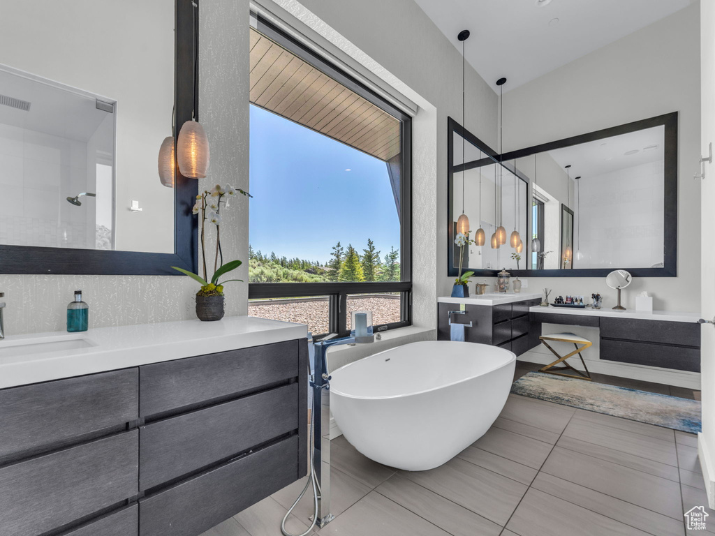 Full bath with a freestanding tub and vanity