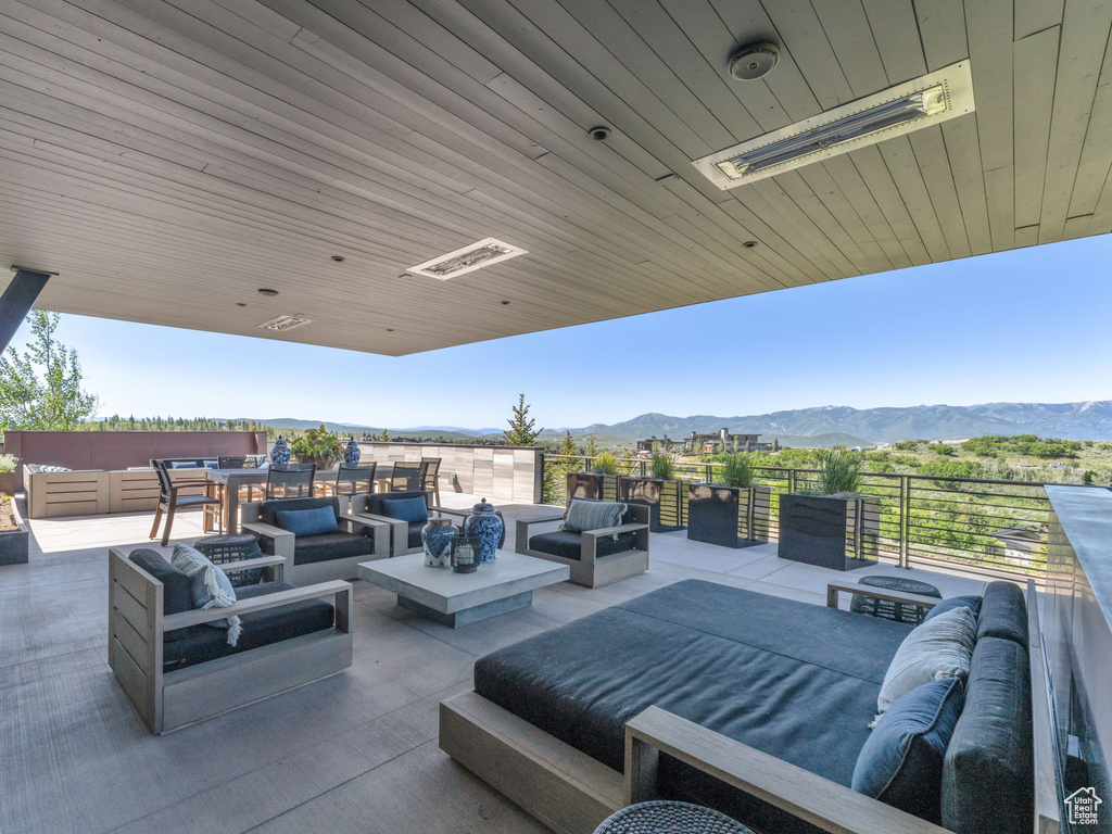 View of patio / terrace with an outdoor living space and a mountain view