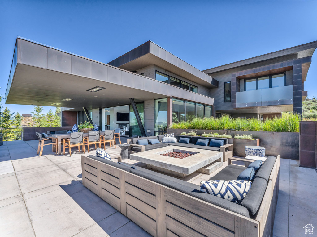 View of patio / terrace featuring an outdoor living space with a fire pit