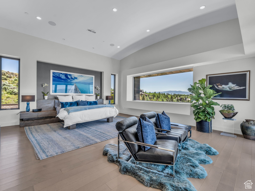 Bedroom featuring vaulted ceiling, recessed lighting, and wood finished floors
