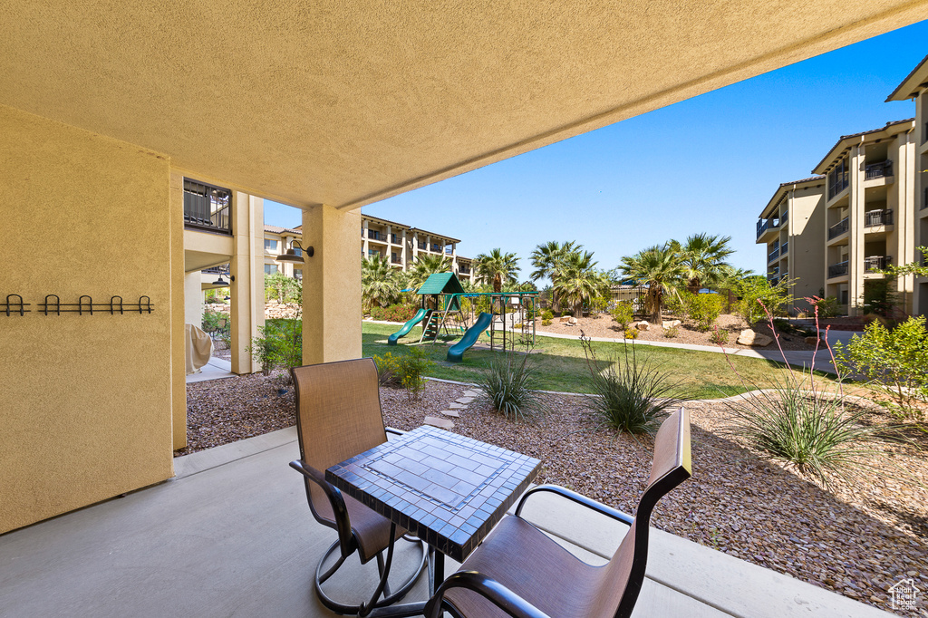View of patio / terrace with a playground and outdoor dining area