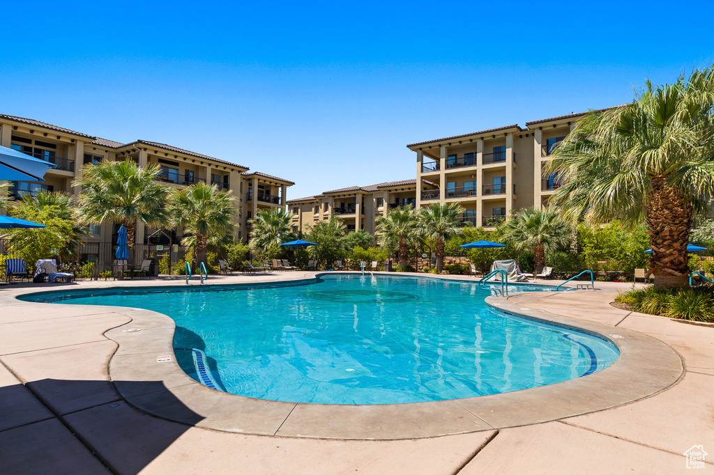Community pool with a patio