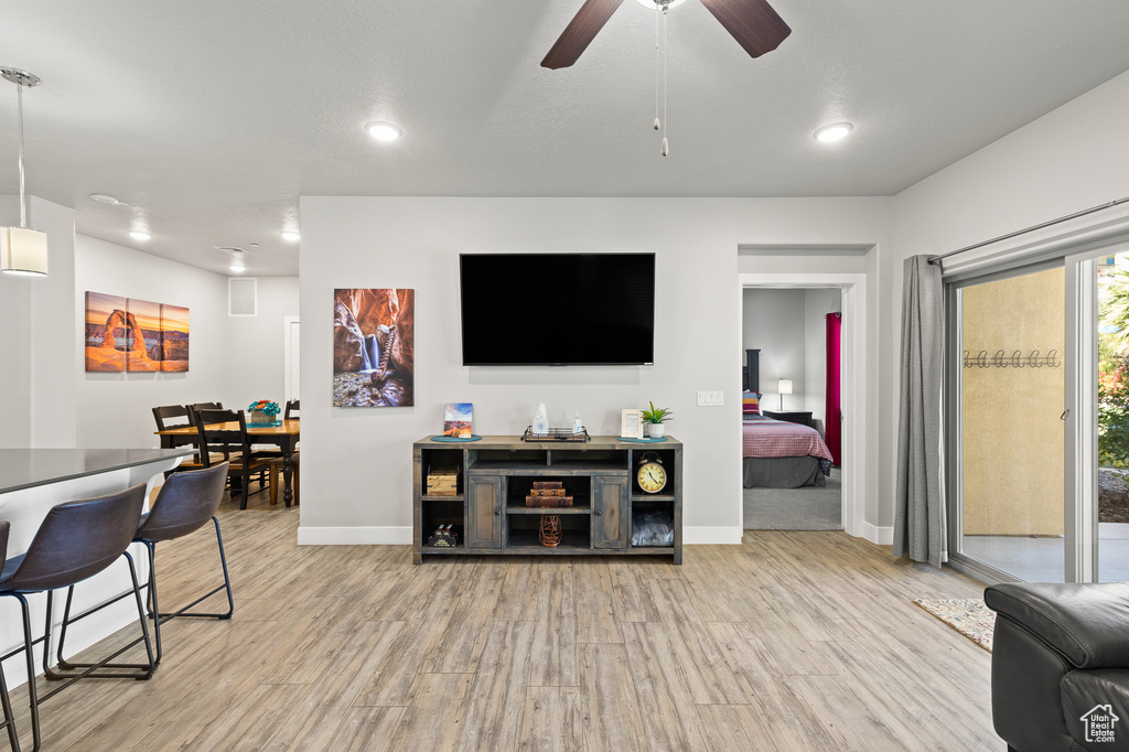 Living room featuring light wood-style floors, recessed lighting, and a ceiling fan