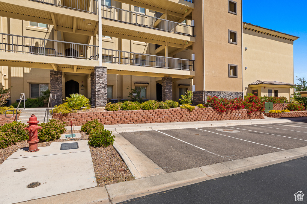 View of property with uncovered parking