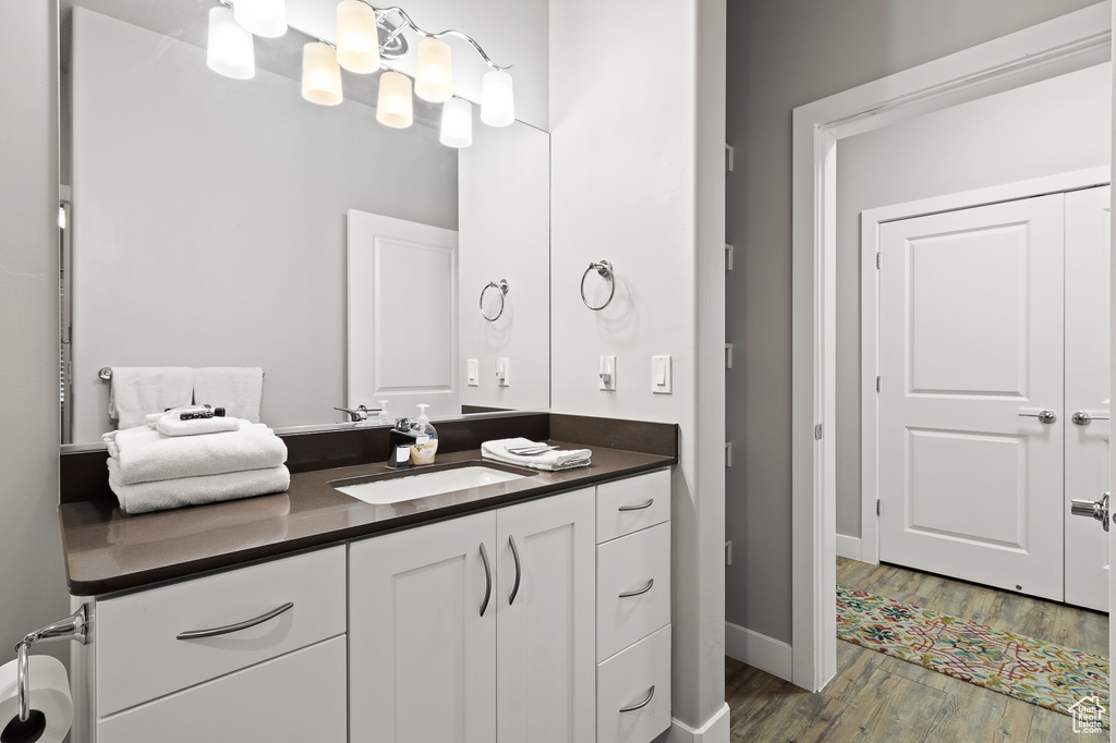 Bathroom featuring vanity and wood finished floors