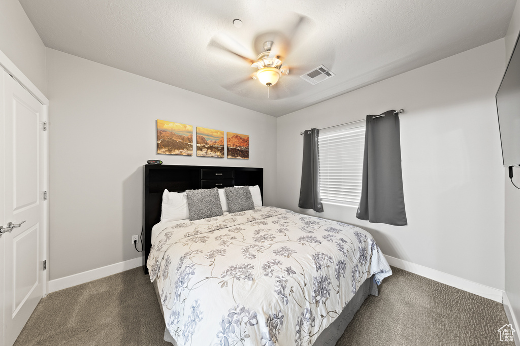 Bedroom with carpet and ceiling fan
