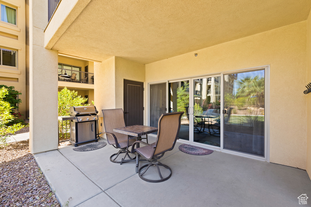 View of patio with a grill and outdoor dining space