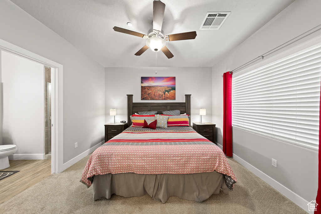 Bedroom with light carpet and ceiling fan