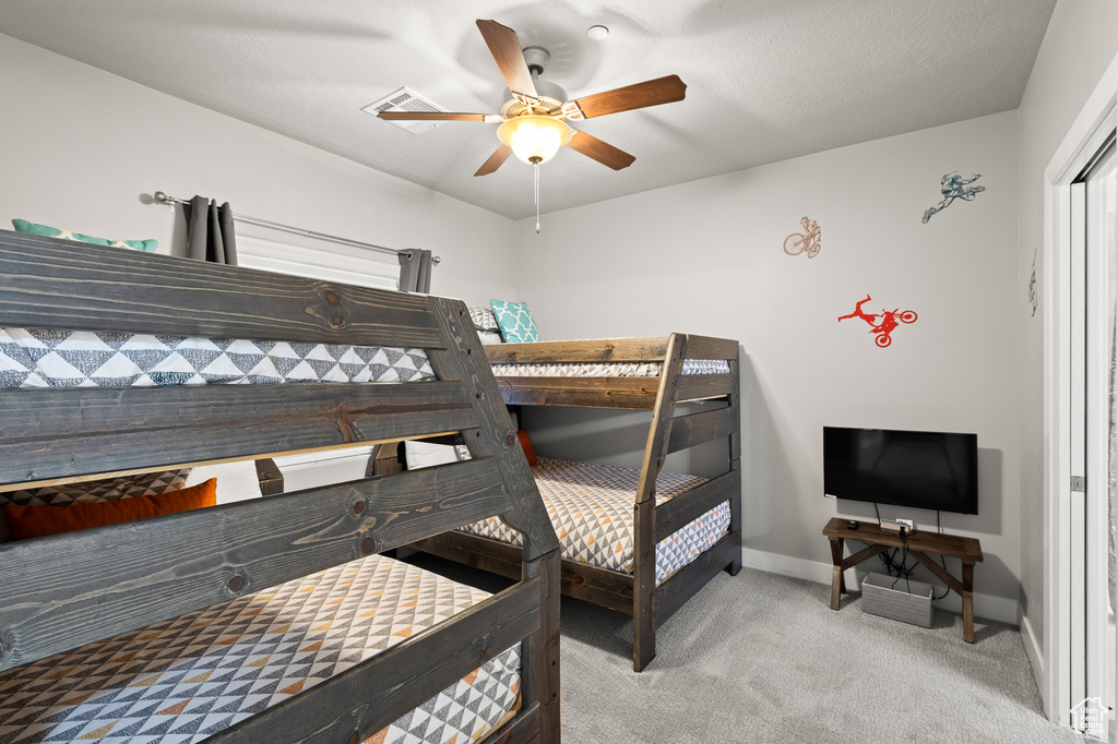 Bedroom with carpet floors and a ceiling fan