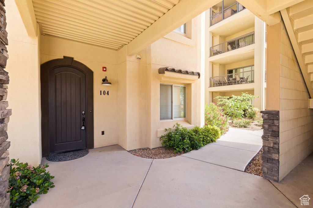 Doorway to property featuring stucco siding