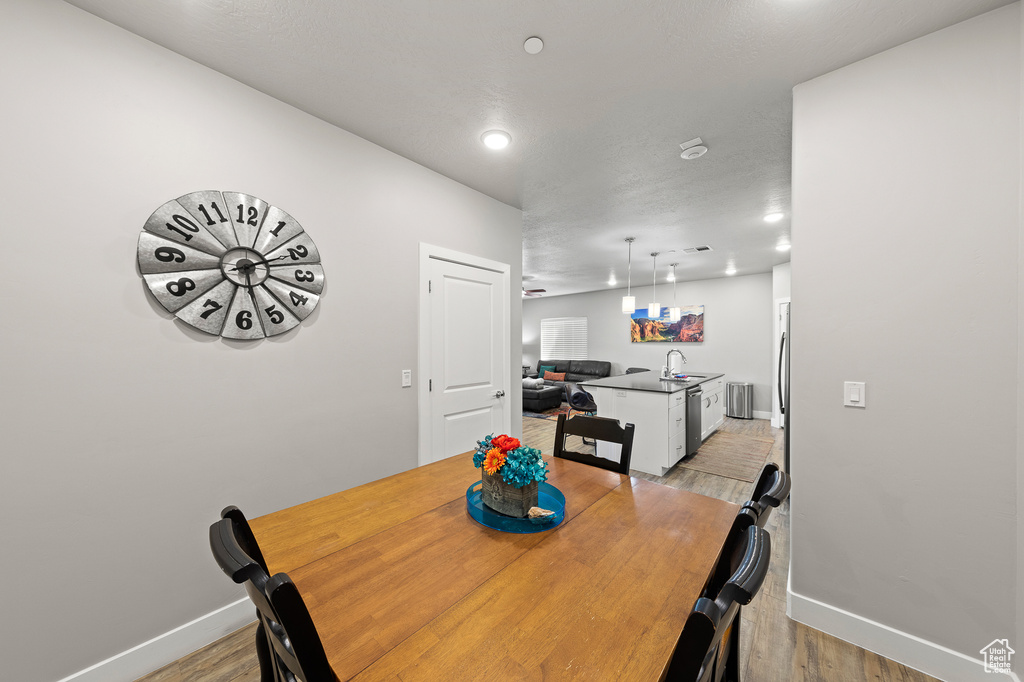 Dining space featuring light wood-style floors and recessed lighting