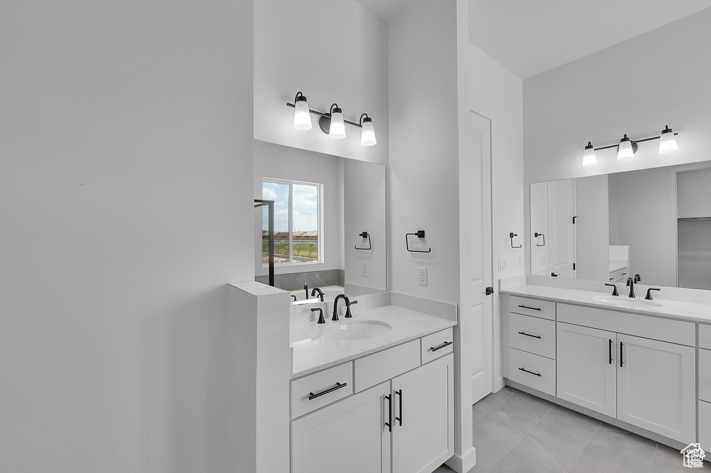 Full bathroom featuring two vanities