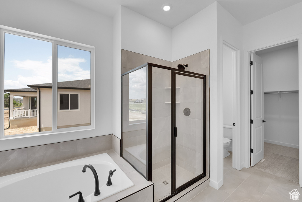 Full bath with a shower stall, a bath, and recessed lighting
