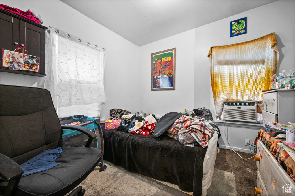 Bedroom with carpet floors and cooling unit