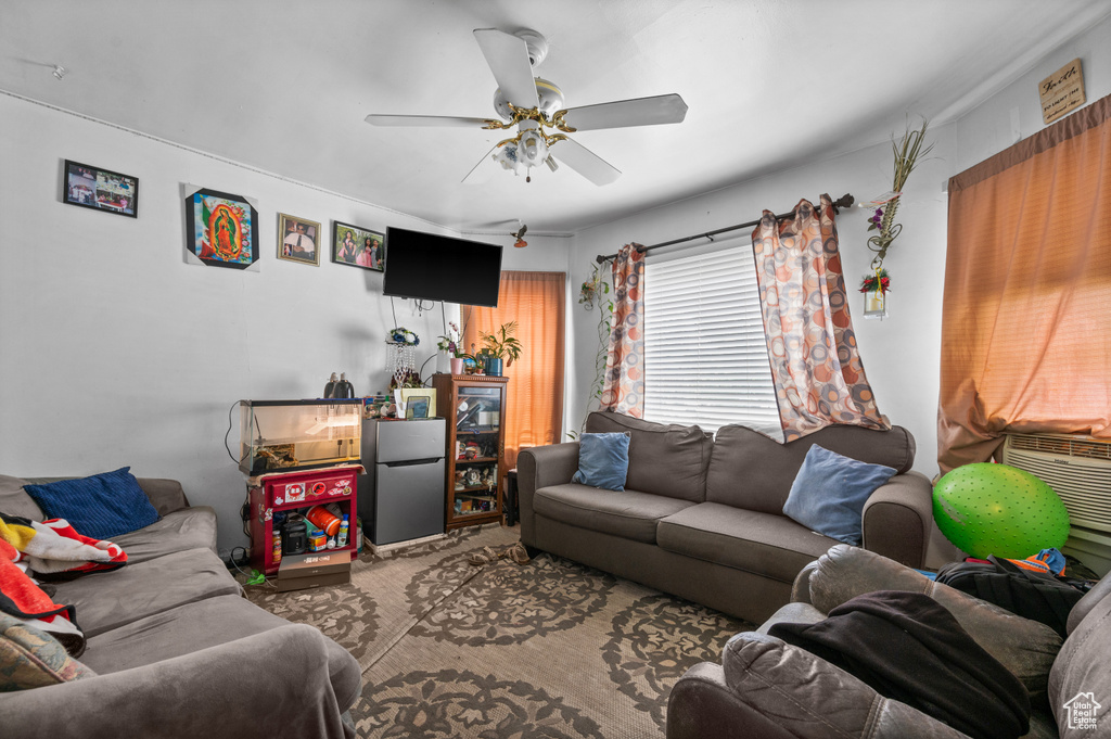 Living area with ceiling fan and carpet floors